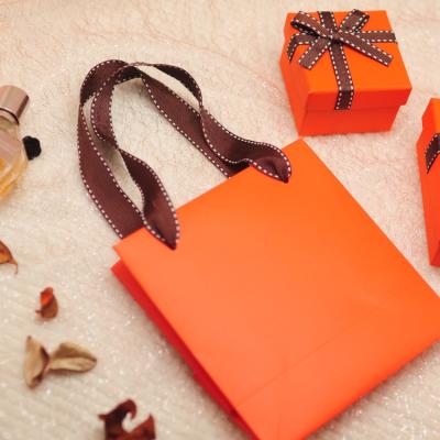 China Orange Recycled Materials Instagram Style Handbag Birthday Gift High End Candy Packaging Custom Logo for sale