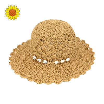 China Adorable Character Summer Foldable Women Hand Crochet Twisted Paper Straw Wide Brim Floppy Sun Hat Sea Shell As Trim for sale