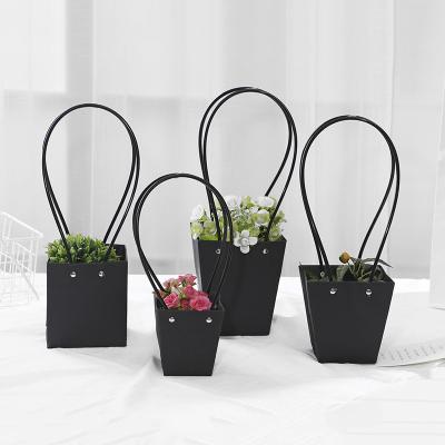 China Recyclable Customize Logo Black Waterproof Kraft Bags Trapezoid And Rectangle Plant Flower Box Baskets Flower Wrapping Valentine's Day for sale