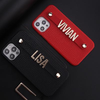 China Funda de cuero iphone striped metal letters sliding strap luxury pebble leather phone case for iPhone 13promax 12 pro X/XS max for sale