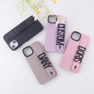 China Custom Name Pebble Leather Strap Leather Phone Case Phone Case With Letter Charm for sale