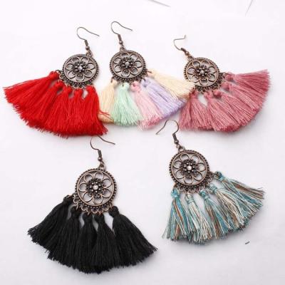 China TRENDY Bohemian Style Trendy Drop Earrings For Women Retro Hollow Flower Circle Alloy Tassel Earrings for sale