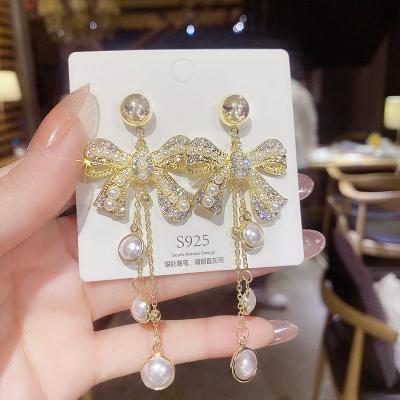 China TRENDY Full Diamond Bowknot Exaggerated Earrings Pearl Tassel Earrings Long Style Party Women Elegant Trendy Earrings for sale