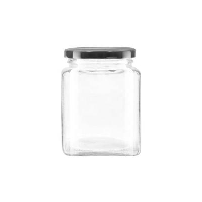 China Hot sale 650ml clear empty square food glass jar for food honey jar with metal lid for sale