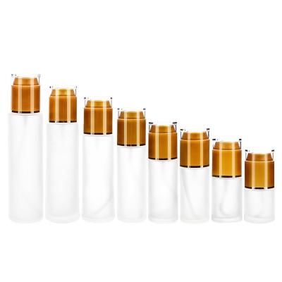 China Hot Selling Cover Scrub Lotion Glass Bottle Squeezing Type Gold Lid Essence Bottle Skin Care Product Push Glass Bottle for sale