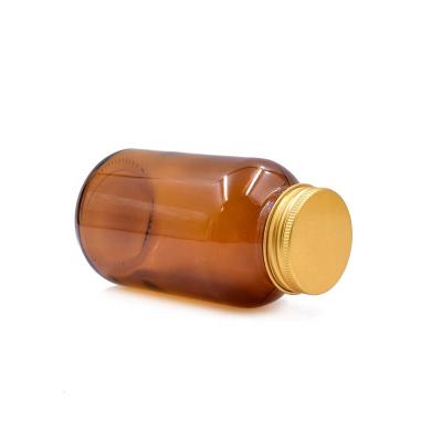 China Eco-friendly RTS 250ml Recyclable Wholesale Pharmaceutical Glass Pills Bottle Wide Mouth Tablet Amber Glass Jar With Gold Screw Lid for sale