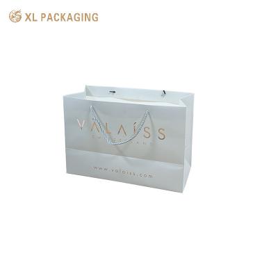 China Gift Paper Packaging Bags Hard Luxury White Art Paper shopping Bag Custom Logo for sale