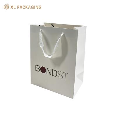 China Professional Custom Paper Bag White Edge White One For Shopping Clothing Shoes Packing Shopping Bag With Logo for sale