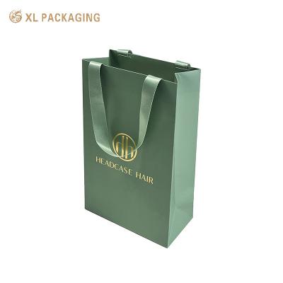 China Custom Design Printed Shopping Gift Packaging Paper Bag With Your Own Logo Luxury green ribbon Thick Paper Bag for Clothes for sale