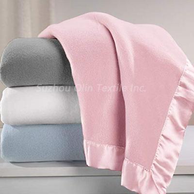 China Custom Baby Sleep Baby Plush Fleece Receiving Blanket With Satin Trim for sale