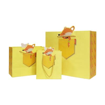 China Recyclable High Quality Yellow Paper Packaging Bag Cute Cartoon Paper Bag With Three Strand Rope for sale