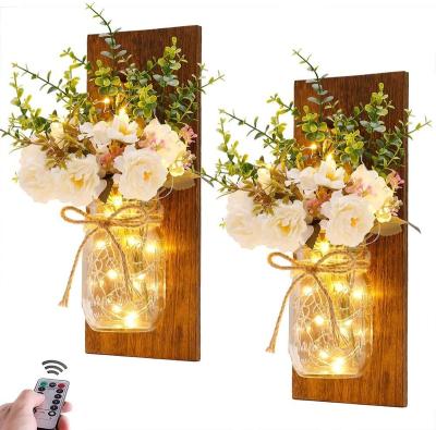 China Rustic Minimalist Mason Jar Sconces Handmade Wall Art Hanging Design with Remote Control LED Fairy Lights and White Peony for sale