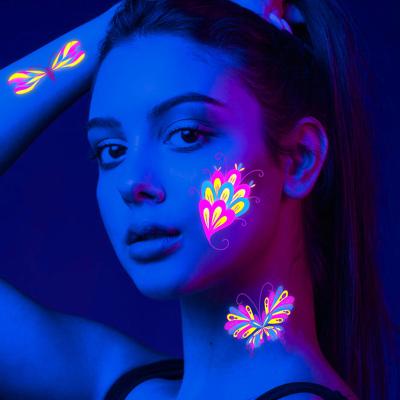 China Temporary UV blacklight Neon butterfly tattoo Christmas Halloween festival accessory glow in the dark makeup temporary tattoo sticker for sale