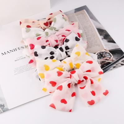 China Thte Popular Wholesale Fabric Cute Bows Women Girls Hair Accessories Lovely Heart Print Hair Clips for sale