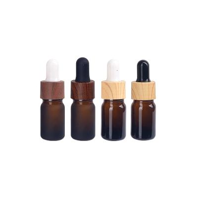 China 5ml Personal Care Essential Oil Glass Bottles Empty Frosted Amber Glass Bottle With 18mm Wood Grain Plastic Dropper Cap for sale