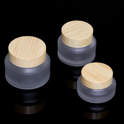 China 15g 30g 50g Tilted Wooden Grain Cosmetic Packaging Water Transfer Wooden Grain Shoulder Cream Frosted Glass Jar With Lid And Water Transfer Wooden Spoon for sale