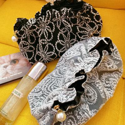 China Fashion lace up black embroidery temperament makeup bag women large capacity portable storage bag for sale