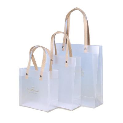 China Recyclable Wholesale Plastic Frosted PP Shopping Tote Bag Customized PVC Transparent Gift Bag With Rivet for sale