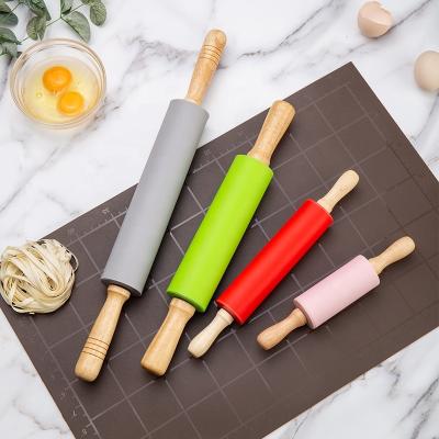 China Sustainable Kitchen Tool Silicone Nonstick Pin For Baking With Stable Wooden Handle for sale