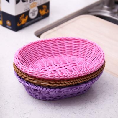 China Eco-friendly Type Sustainable Handwoven Colorful Oval PP Rattan Bread Basket Fruit Display Storage Basket for sale