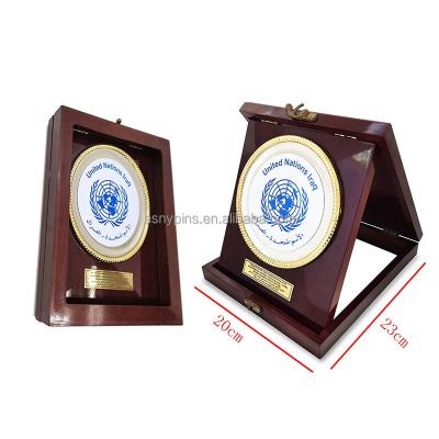 China Iraq Custom Design Rotating Logo High Quality Promotional New Medal Trophy With Red Wooden Base for sale