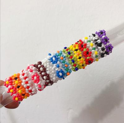 China FASHIONABLE Korean Daisy Floret Color Joint Ring Hand Weaving Beautiful Fun Flower Ring for sale