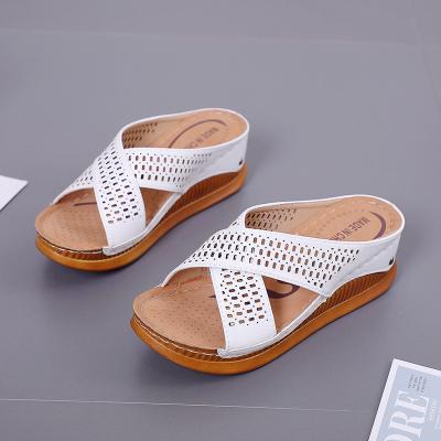 China 2022 summer fashion trend hollow shoes women's breathable cross wedge heel PU slide slipper mother sandals for sale