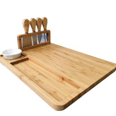 China Amazon Sustainable Bamboo Cheese Board Set Serving Meat Board Tray Including Stainless Steel 4 Knife and Serving Utensils for sale