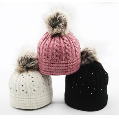 China COMMON Winter Knitted Women's Rhinestone Stitching Skull Beanie Outdoor Fur Pompom Hat for sale