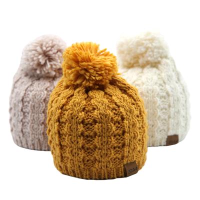 China High Quality COMMON Label Winter Wool Blend Pom Pom Knitted Beanie With Leather For Women for sale