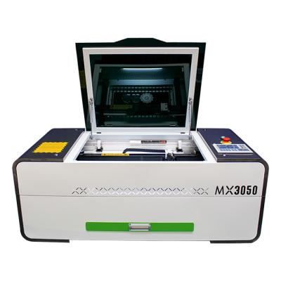 China Fast Traceability MingXing Laser CO2 Laser Engraving and Cutting Machine Desktop Mini Laser Engraver with up and down table for sale