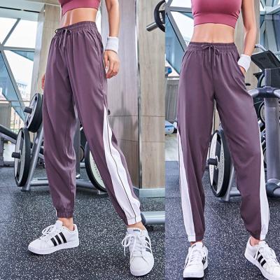 China Sports QUICK DRY Slim Quick Dry Pants Maiden Loosely Tied Feet Fitness Solid Color Pocket Running Women Jogging Pants for sale