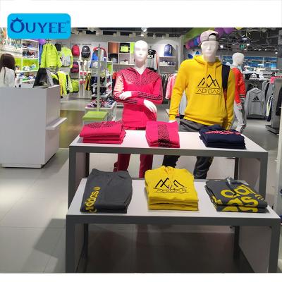 China Customized Men's Clothing Showroom Interior Design Simple Sports Shop Room Design Wooden Garment Wall Metal Customized Display Racks exhibition of men's clothing for sale