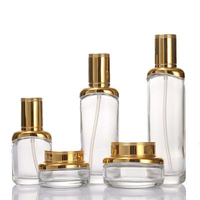 China Logo Luxury Clear Glass Custom Cosmetic Packaging 30g 50g Face Jar 40ml 100ml 120ml Lotion Pump Bottle With Gold Cap for sale