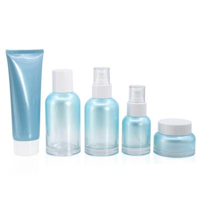 China Ocean Cosmetic Blue Glass Cosmetic Packaging Set 50g Cream Jar 40ml 100ml 120ml Body Lotion Pump Bottle Atomizer Perfume Spray Bottle for sale