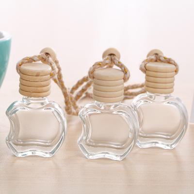 China Mini Glass Aroma Essential Oil Bottle 10ml Clear Apple Shape Car Cosmetic Wholesale Perfume Bottle With Wooden Cap for sale