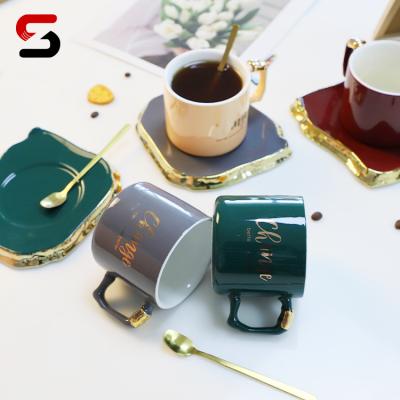 China Wholesale Nordic Viable Style Home Ceramic Coffee Cups Mugs Art Decor Ceramic Coffee Cup and Saucer Sets Irregular Golden Handle for sale