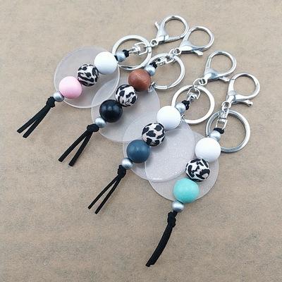 China Silicone Personalized Disc Acrylic Silicone Beaded Suede Wood Tassel Key Chain Monogram Bead Key Chain for sale