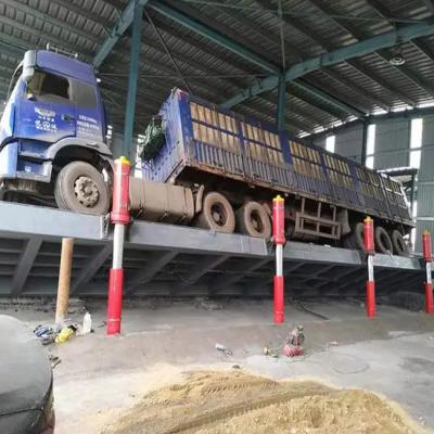 China Enclosed Hydraulic Truck Unloader With Side And Backward Flipping For Efficient Cargo Handling for sale