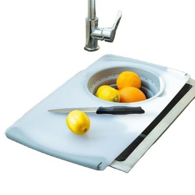 China Sink Viable Multifunctional Cutting Board Plastic Cutting Board With Folding Drain Storage Basket for sale