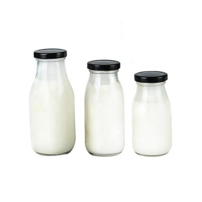 China Wholesale Beverage Round 200ml Milk Juice Glass Bottles With Screw Metal Cap for sale