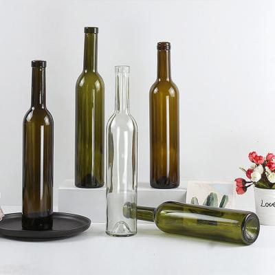 China Hot Sale Empty Light Green Amber Round Champagne 500ml Red Glass Wine Bottles With Cork for sale