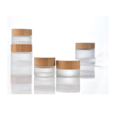 China Cosmetic skin care container1oz 5ml 10ml 30ml 50m 100ml frosted face fancy glass eye cream cosmetic jar with bamboo lid for sale