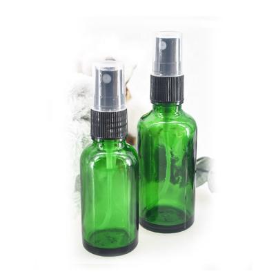 China Personal Care 50ml Green Round Cosmetic Mist Spray Glass Bottle With Fine Mist Sprayer for sale