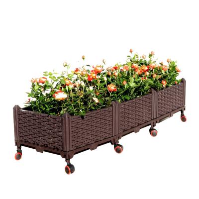 China Corrosion Resistance Self Watering Plastic Rectangular High Bed With Wheels Raised Plastic Outdoor Garden Plant Flowerpot Planting Box for sale