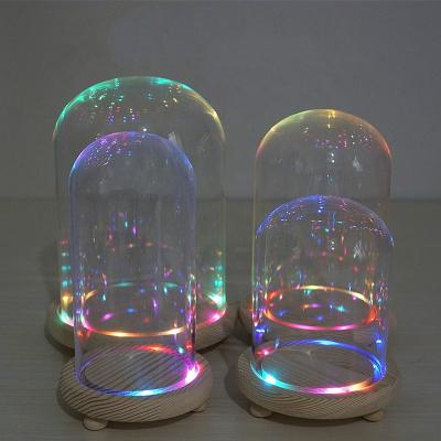 China Art Hot Sale Diameter 9cm Folk Clear Rose Dome Bell Glass Bell Jar With LED Light Wooden Base for sale