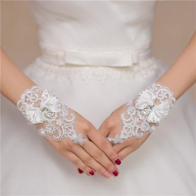 China Wrist Length Crystal White Short Bow Style Lace Up Bride Hand Gloves Fast Delivery for sale