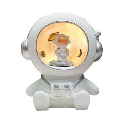 China Creative Eco-friendly Natural Design Astronaut Night Light Polyresin Piggy Bank With Led Lights for sale