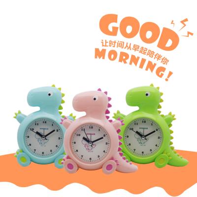 China Cute Alarm Dinosaur Alarm Clock Student Cartoon Alarm Clock Toy Antair Nightstand for sale