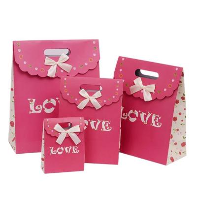 China Recyclable High Quality Custom Reusable Small Christmas Gift Shopping Paper Bag With Bow for sale